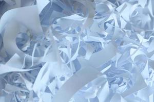 Shredded paper texture background, top view of many white paper strips. Pile of cut paper like box filler for shipping fragile items photo