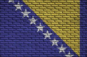 Bosnia and Herzegovina flag is painted onto an old brick wall photo