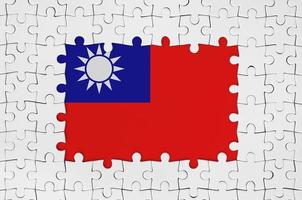 Taiwan flag in frame of white puzzle pieces with missing central part photo