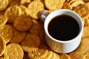 Small coffee cup and salted cracker photo