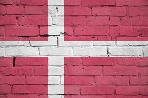 Denmark flag is painted onto an old brick wall photo