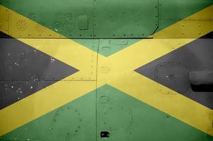 Jamaica flag depicted on side part of military armored helicopter closeup. Army forces aircraft conceptual background photo