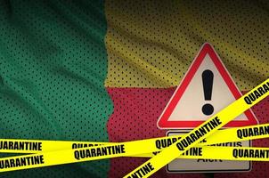 Benin flag and Covid-19 quarantine yellow tape. Coronavirus or 2019-nCov virus photo