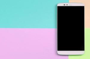 Modern smartphone with black screen on texture background of fashion pastel pink, blue, coral and lime colors photo