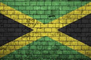 Jamaica flag is painted onto an old brick wall photo