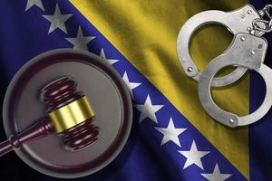 Bosnia and Herzegovina flag with judge mallet and handcuffs in dark room. Concept of criminal and punishment, background for judgement topics photo