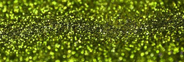 Lime green decorative sequins. Background image with shiny bokeh lights from small elements photo