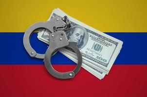 Venezuela flag with handcuffs and a bundle of dollars. Currency corruption in the country. Financial crimes photo