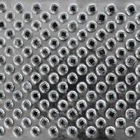 A fragment of a metal chrome grater close-up. Texture of blades for grinding food photo