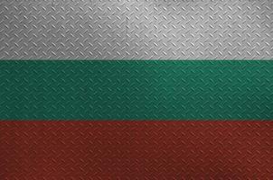 Bulgaria flag depicted in paint colors on old brushed metal plate or wall closeup. Textured banner on rough background photo