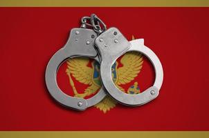 Montenegro flag and police handcuffs. The concept of observance of the law in the country and protection from crime photo