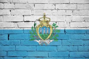 San Marino flag is painted onto an old brick wall photo