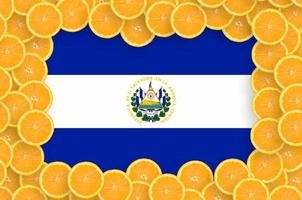 El Salvador flag in fresh citrus fruit slices frame photo