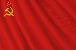 Soviet Union flag with big folds waving close up under the studio light indoors. The official symbols and colors in banner photo