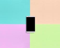 Modern smartphone with black screen on texture background of fashion pastel pink, blue, coral and lime colors photo