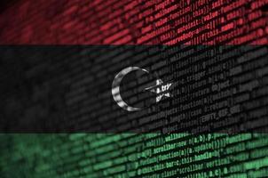 Libya flag is depicted on the screen with the program code. The concept of modern technology and site development photo