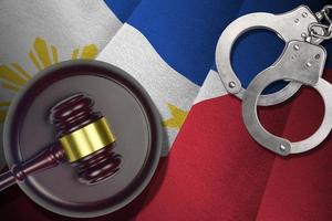 Philippines flag with judge mallet and handcuffs in dark room. Concept of criminal and punishment, background for judgement topics photo