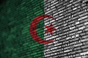 Algeria flag is depicted on the screen with the program code. The concept of modern technology and site development photo