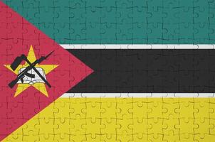 Mozambique flag is depicted on a folded puzzle photo