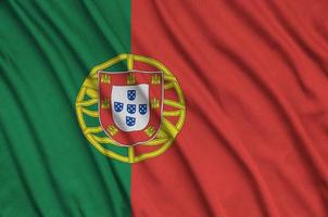 Portugal flag is depicted on a sports cloth fabric with many folds. Sport team banner photo