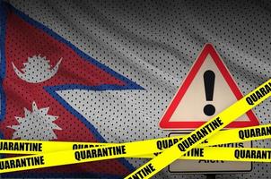 Nepal flag and Covid-19 quarantine yellow tape. Coronavirus or 2019-nCov virus photo