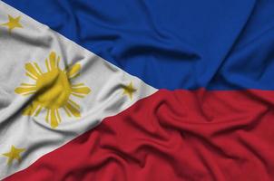 Philippines flag is depicted on a sports cloth fabric with many folds. Sport team banner photo