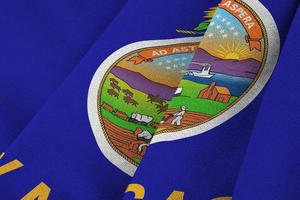 Kansas US state flag with big folds waving close up under the studio light indoors. The official symbols and colors in banner photo