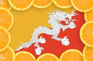 Bhutan flag in fresh citrus fruit slices frame photo