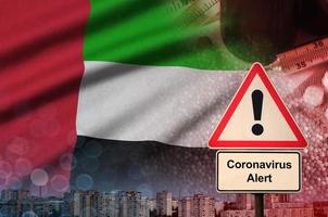 United Arab Emirates flag and Coronavirus 2019-nCoV alert sign. Concept of high probability of novel coronavirus outbreak through traveling tourists photo