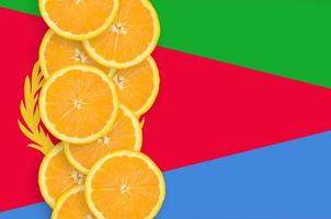 Eritrea flag and citrus fruit slices vertical row photo