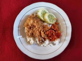 famous ayam geprek food from Indonesia with red carpet background premium photo