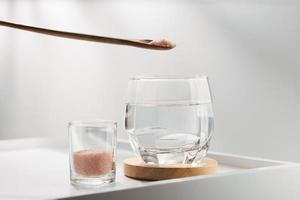 Add pink himalayan mineral salt to your drinking water for health. photo