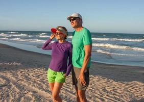 Couple at the beach in Fortaleza, Brazil, known as Future Beach in the late afternoon photo