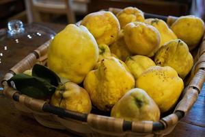 Basket full of yellow quinces. photo