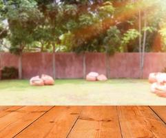 wooden board over blurred garden background photo