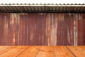 perspective wooden board over blur old rusty galvanized sheet photo