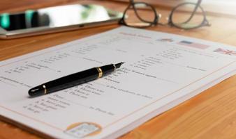 English test with pen on wooden table in class photo