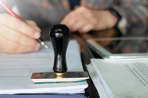 rubber stamper on white paperwork photo