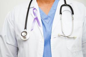 Asian woman doctor with purple ribbon, World Pancreatic Cancer day or World Alzheimer day. photo