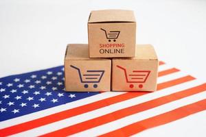 Online shopping, Shopping cart box on USA America flag, import export, finance commerce. photo