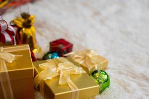 Golden gift boxes with Christmas ornaments photo