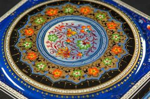 A closeup of a casket with an artistic painting. Central Asia, Uzbekistan photo