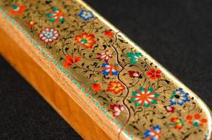 A closeup of a pencil case with artistic painting on a black background. Central Asia, Uzbekistan photo