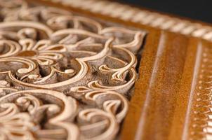 The close-up vintage oriental wooden table with the artistic carving, Uzbekistan photo