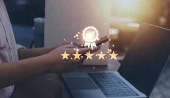Hand shows the sign of the top service Quality assurance, thumb up and 5 star, best product, Guarantee, Standards, ISO certification and standardization concept. photo