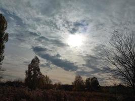 Multi-colored clouds fly over the village photo