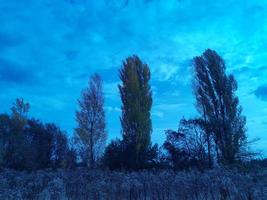 Multi-colored clouds fly over the village photo