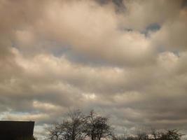 Multi-colored clouds fly over the village photo