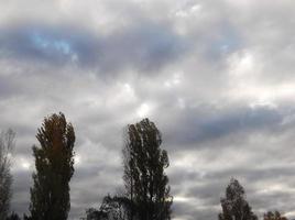 Multi-colored clouds fly over the village photo