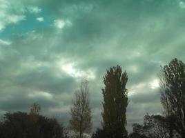 Multi-colored clouds fly over the village photo